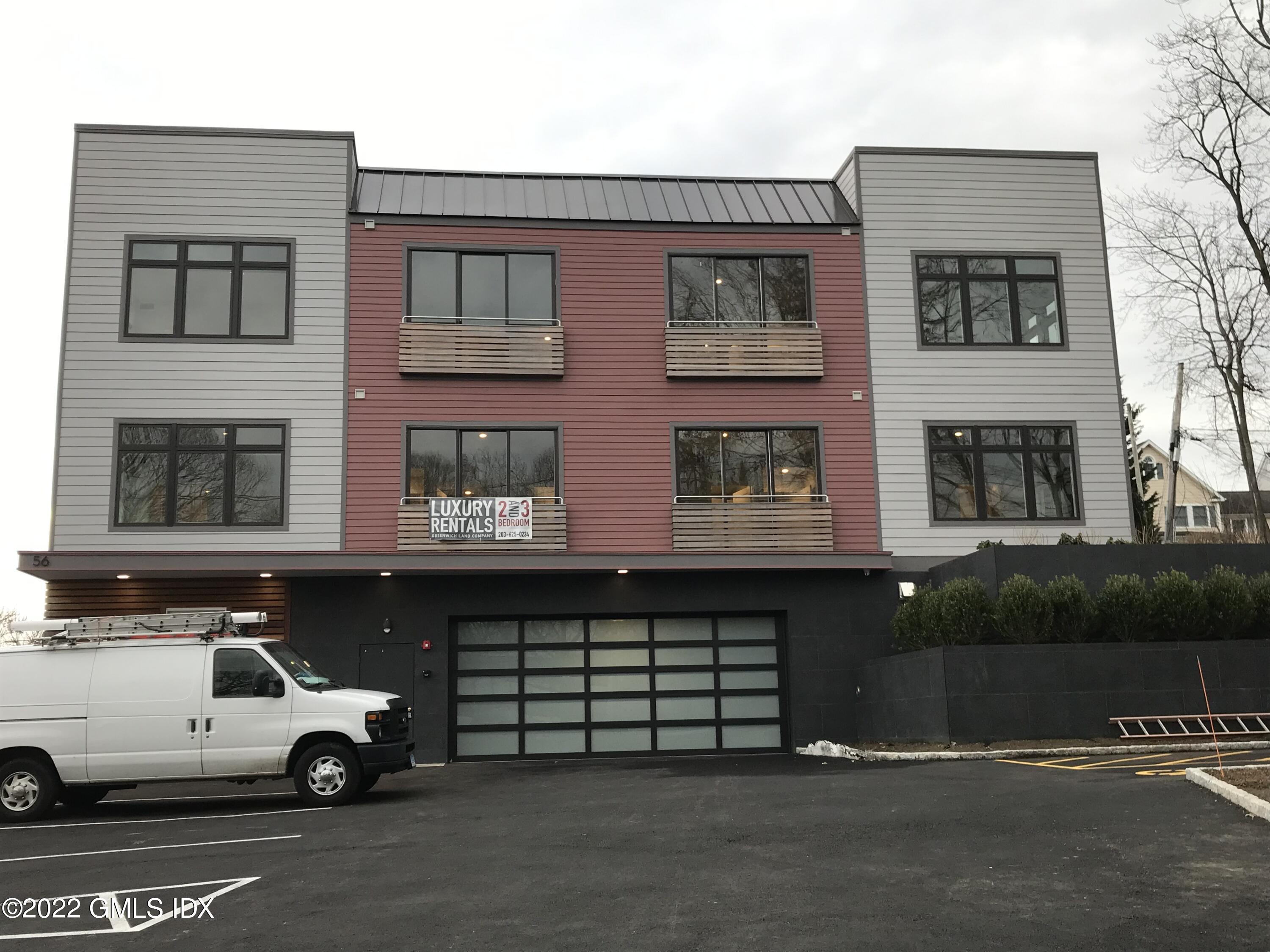56 Old Field Point Road, Unit 6 Greenwich, CT 06830 - Photo 2 of 28 a car parked in front of a building