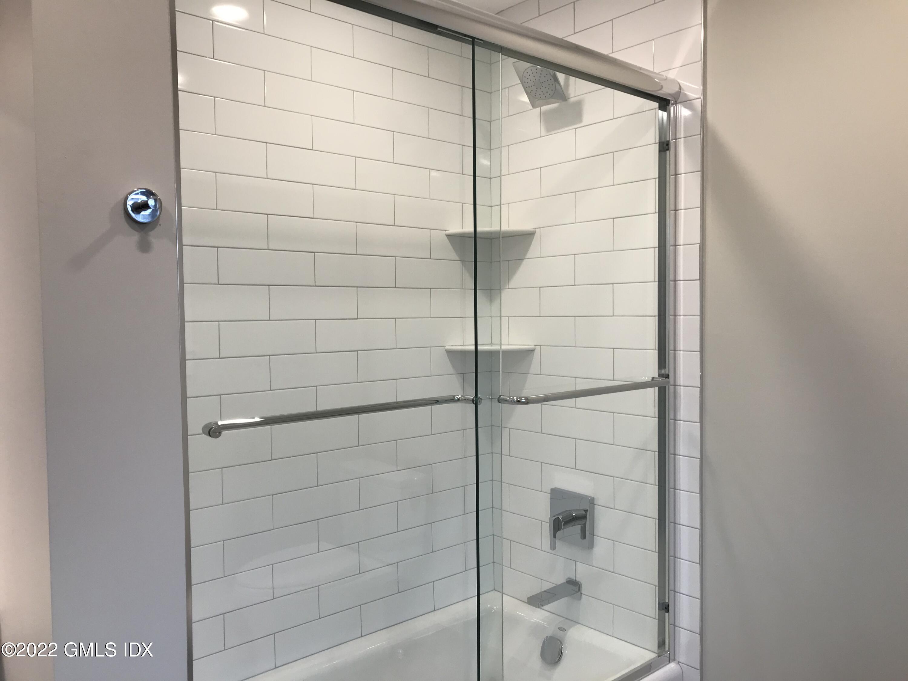 56 Old Field Point Road, Unit 6 Greenwich, CT 06830 - Photo 20 of 28 a bathroom with a shower