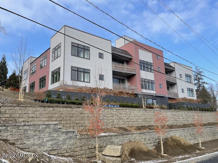 56 Old Field Point Road, Unit 6 Greenwich, CT 06830 - Photo 27 of 28 a front view of a building with street