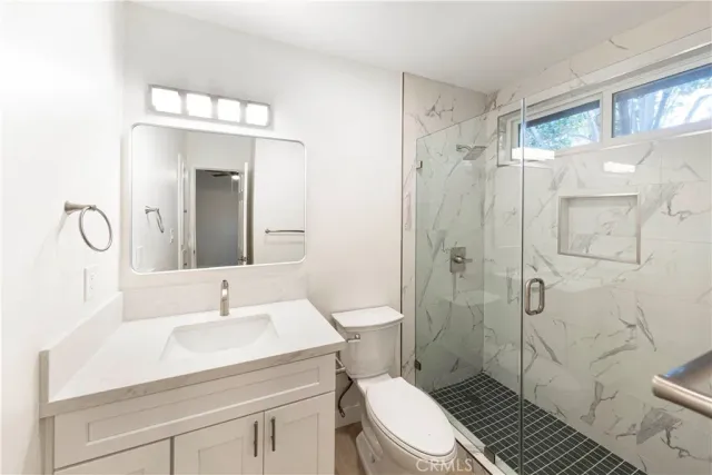 a bathroom with a sink toilet and shower