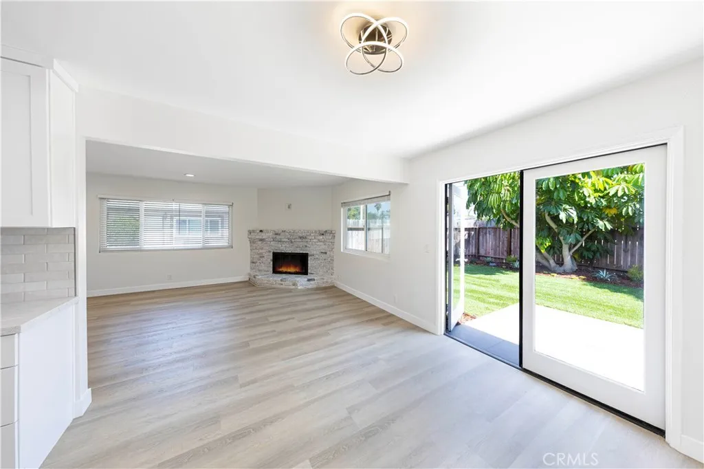 2477 Orange, Unit A Costa Mesa, CA 92626 - Photo 2 of 21 a view of empty room with wooden floor and fireplace