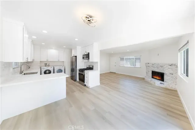 a view of kitchen with furniture and wooden floor