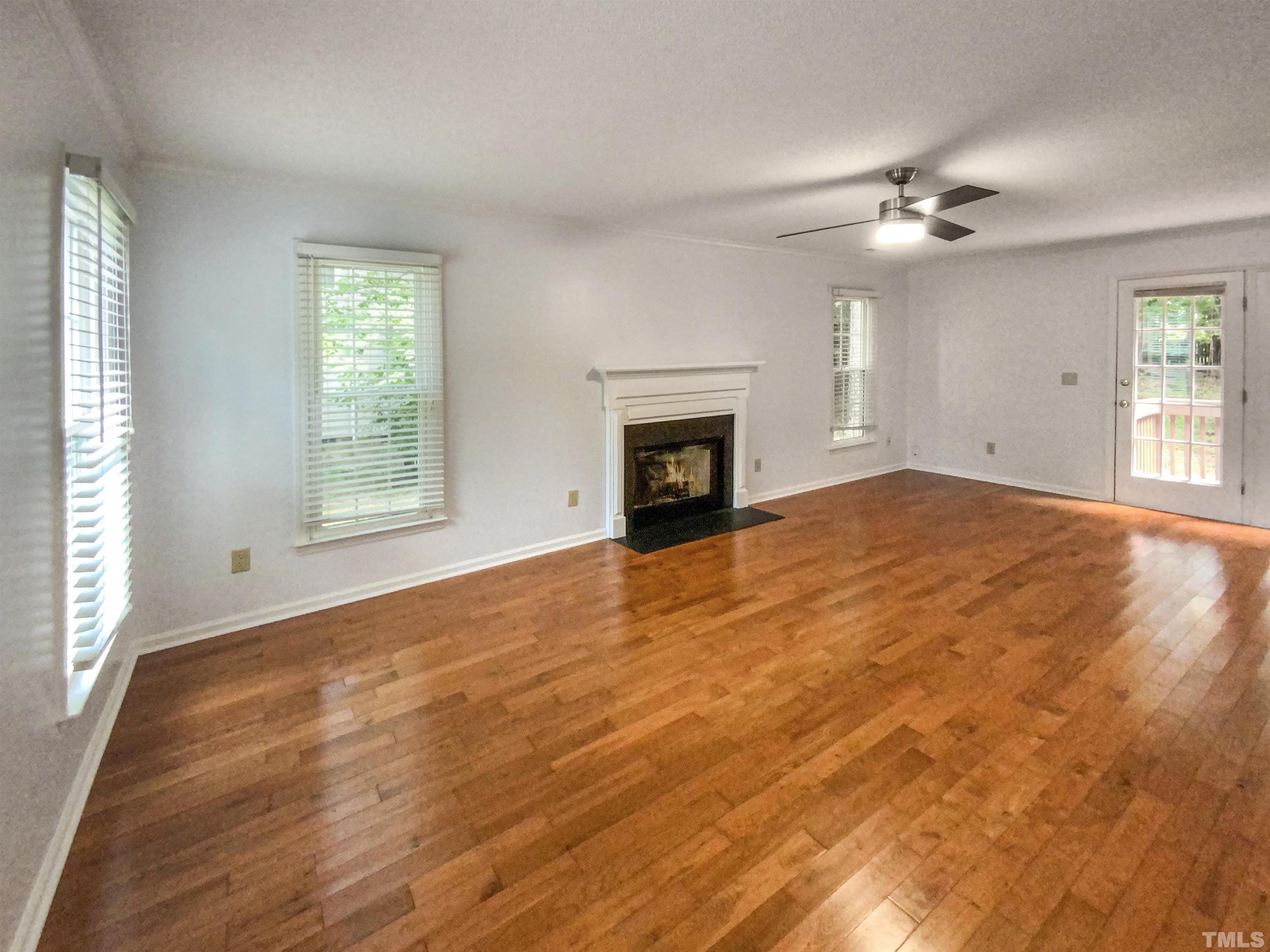 3416 Ribcowski Court Raleigh, NC 27616 - Photo 3 of 18 a view of an empty room with window and wooden floor