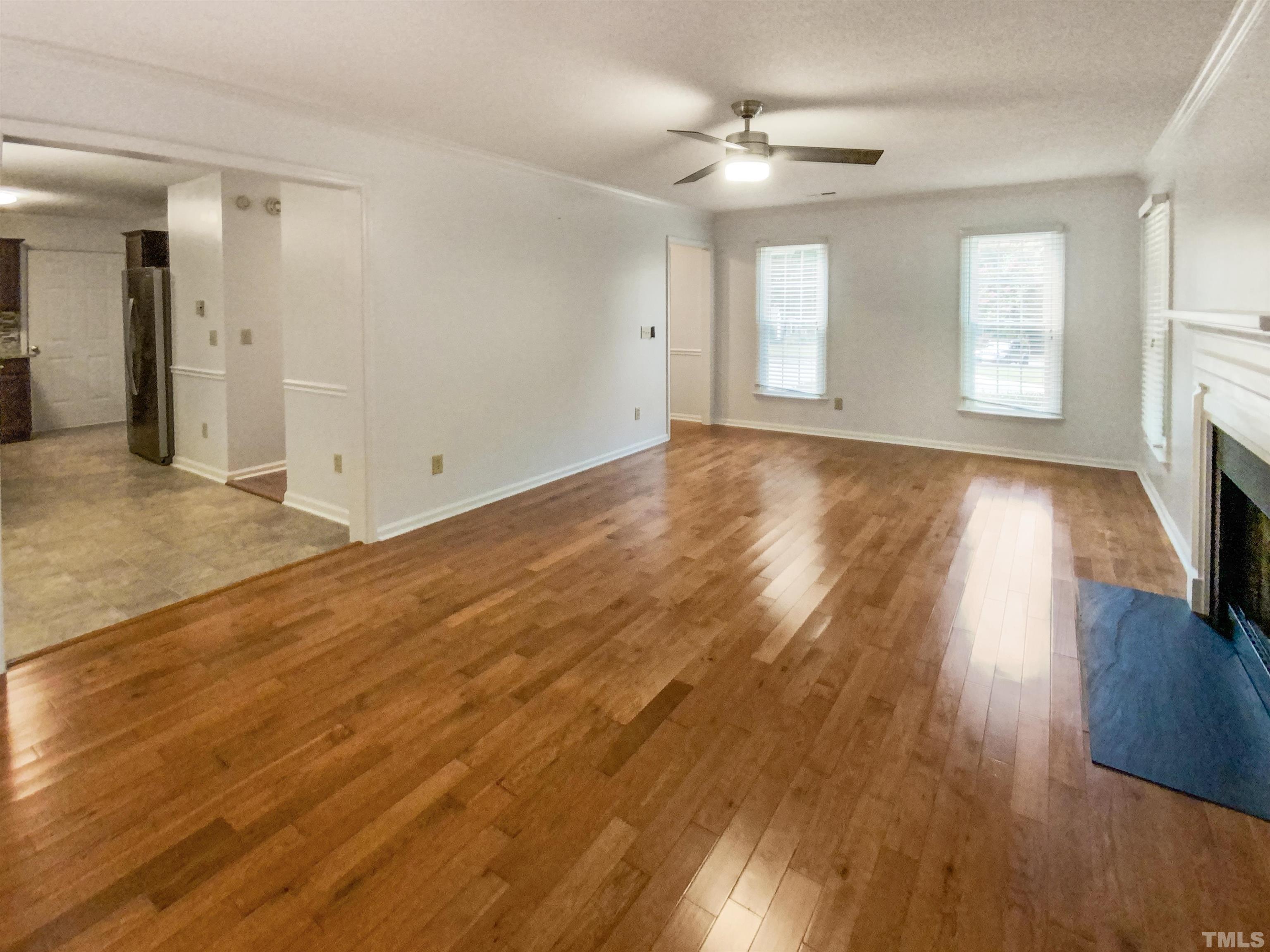 3416 Ribcowski Court Raleigh, NC 27616 - Photo 8 of 18 an empty room with wooden floor and windows