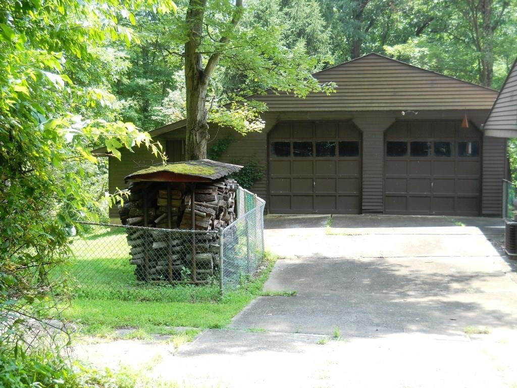 3 - Exterior Front - Detached 2 car garage 38' x 28' with over sized 9' x 9' automatic garage doors and additional storage on left side.  Full walk out basement.  Two wood storage facilities.