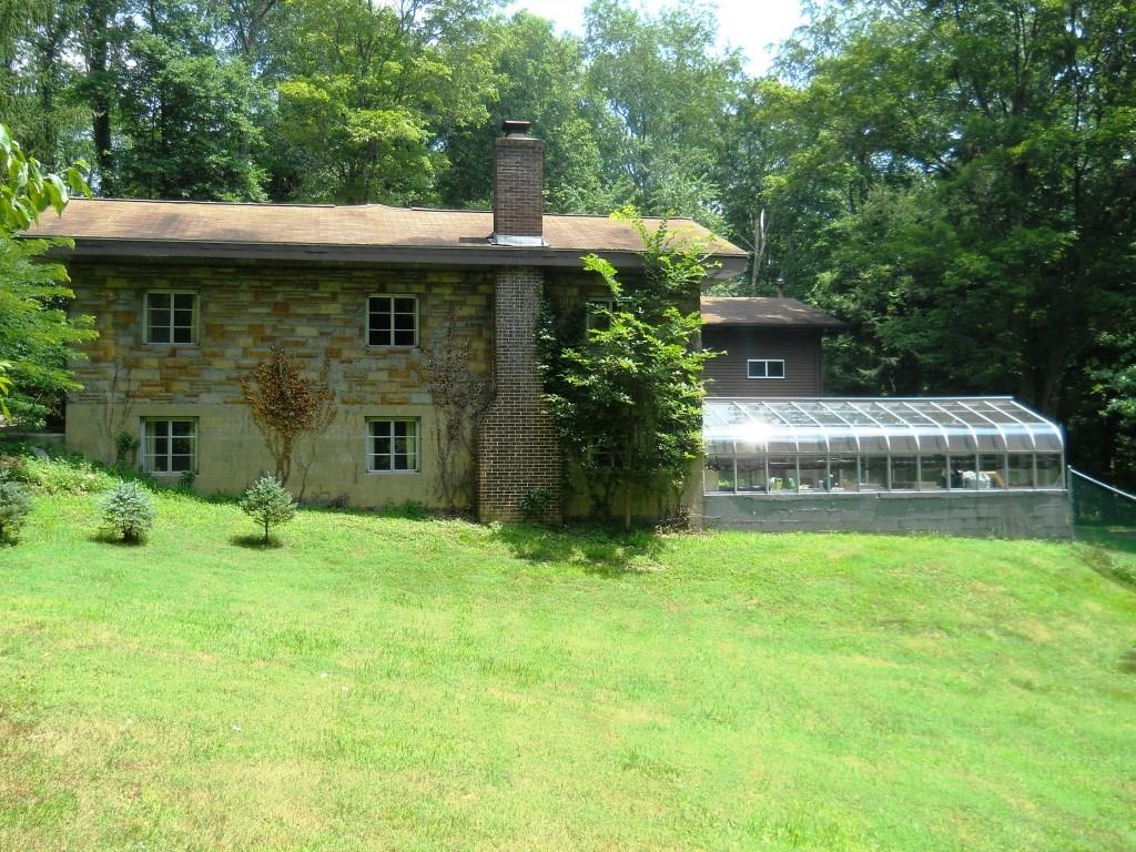 4 - Exterior right side with attached 25' x 13' professional greenhouse and walk out to fenced areas.  Large side yard.