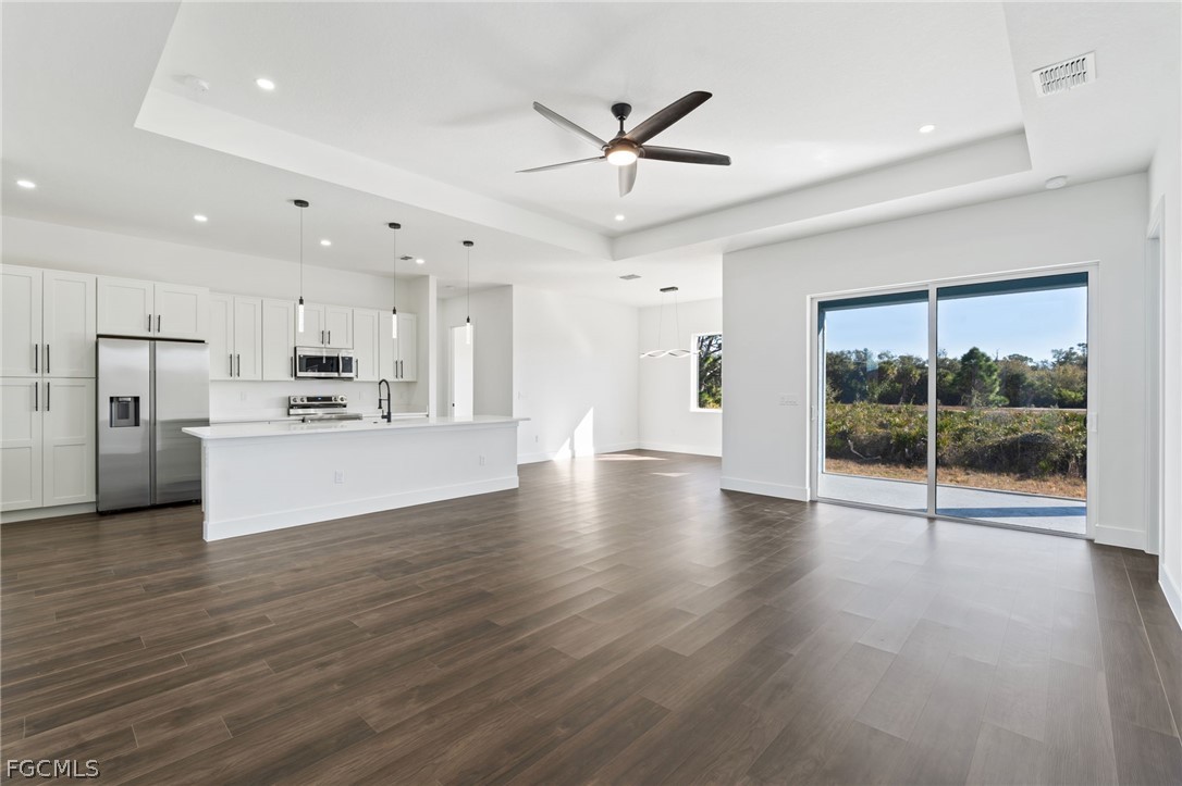 97 Brig Circle East Placida, FL 33946 - Photo 3 of 23 a view of an empty room with wooden floor and a ceiling fan