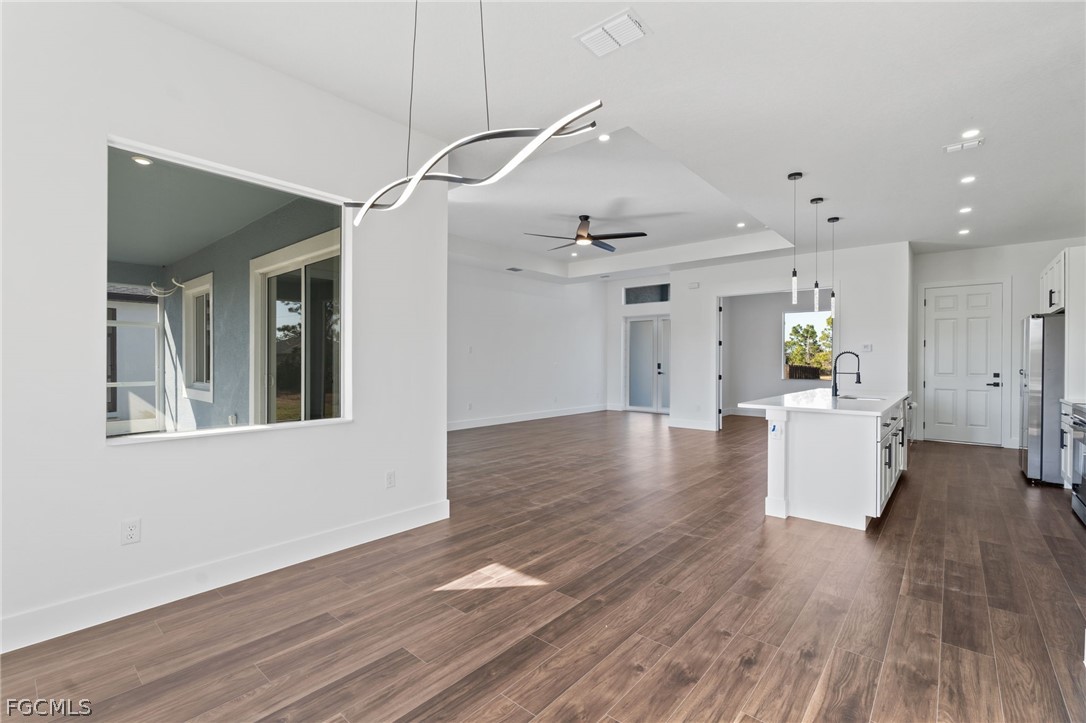 97 Brig Circle East Placida, FL 33946 - Photo 4 of 23 a view of an empty room and kitchen with wooden floor