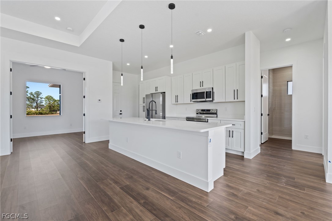 97 Brig Circle East Placida, FL 33946 - Photo 6 of 23 an open kitchen with white cabinets and stainless steel appliances