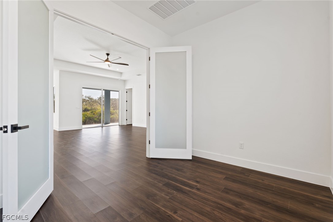 97 Brig Circle East Placida, FL 33946 - Photo 9 of 23 a view of an empty room with wooden floor and a window