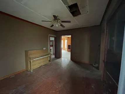 a view of entryway and hall with a ceiling fan