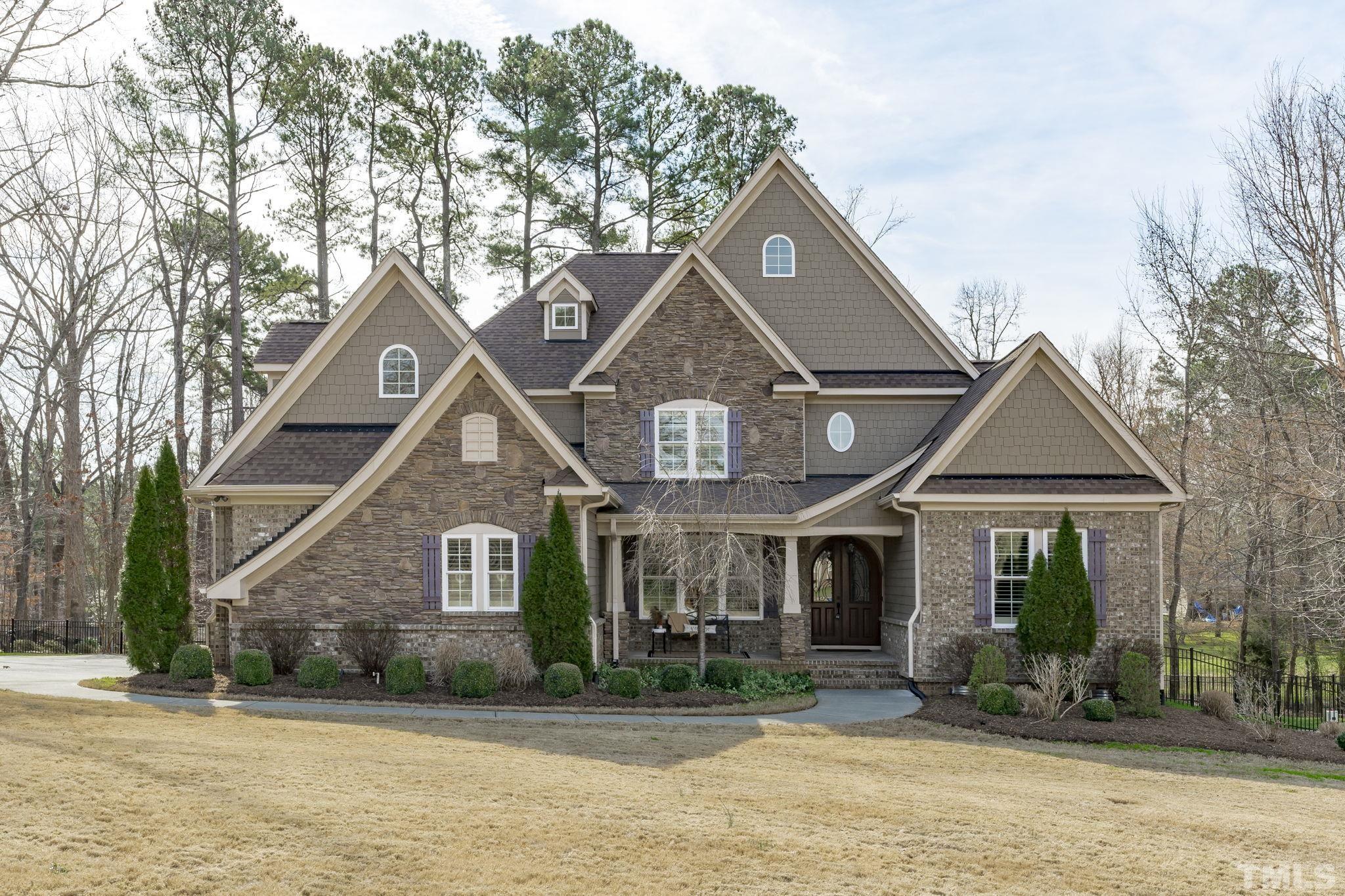 3976 Springfield Trail Wake Forest, NC 27587 - Photo 1 of 35 a front view of a house with garden