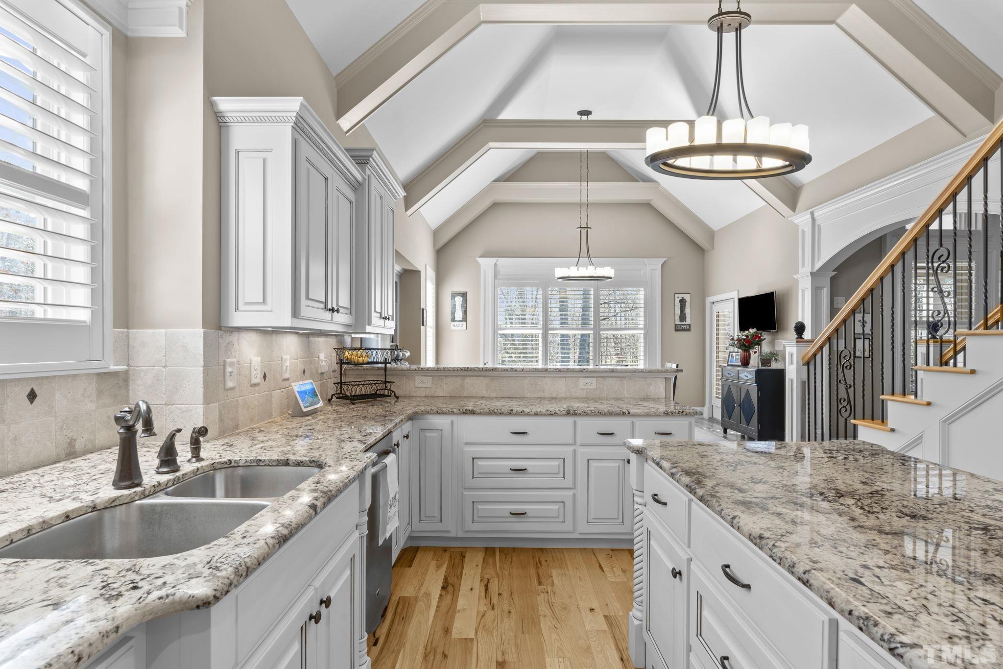 3976 Springfield Trail Wake Forest, NC 27587 - Photo 11 of 35 a kitchen with stainless steel appliances granite countertop a sink stove and cabinets