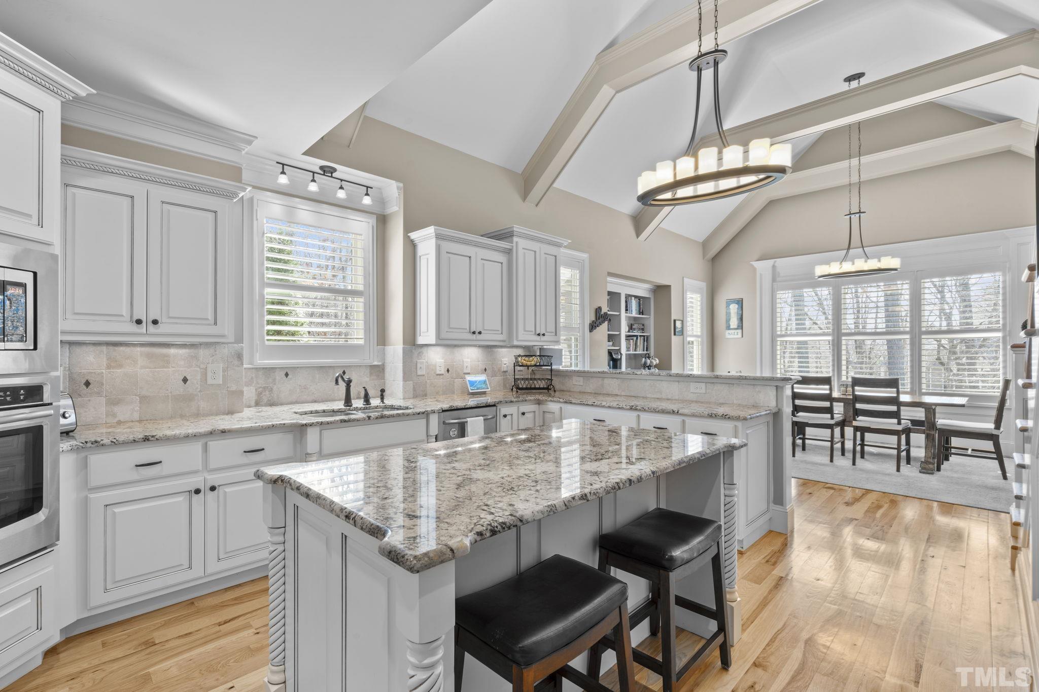 3976 Springfield Trail Wake Forest, NC 27587 - Photo 12 of 35 a kitchen with center island table and chairs