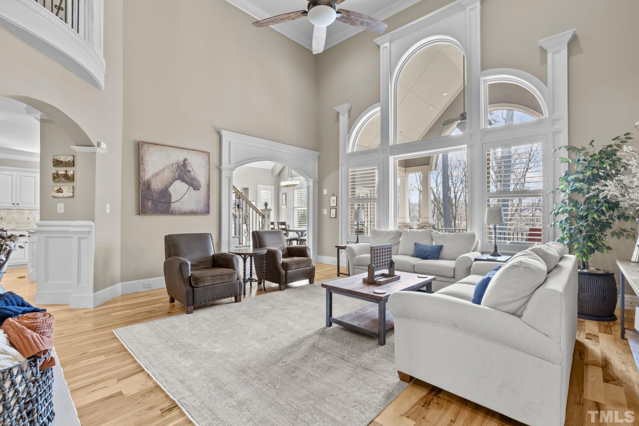 3976 Springfield Trail Wake Forest, NC 27587 - Photo 14 of 35 a living room with furniture a large window and a chandelier