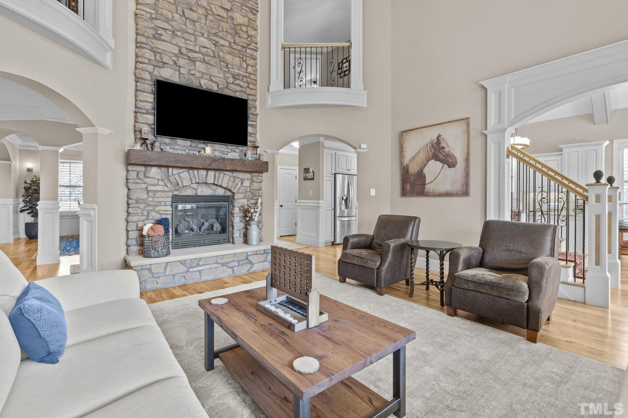 3976 Springfield Trail Wake Forest, NC 27587 - Photo 16 of 35 a living room with furniture a fireplace and a flat screen tv