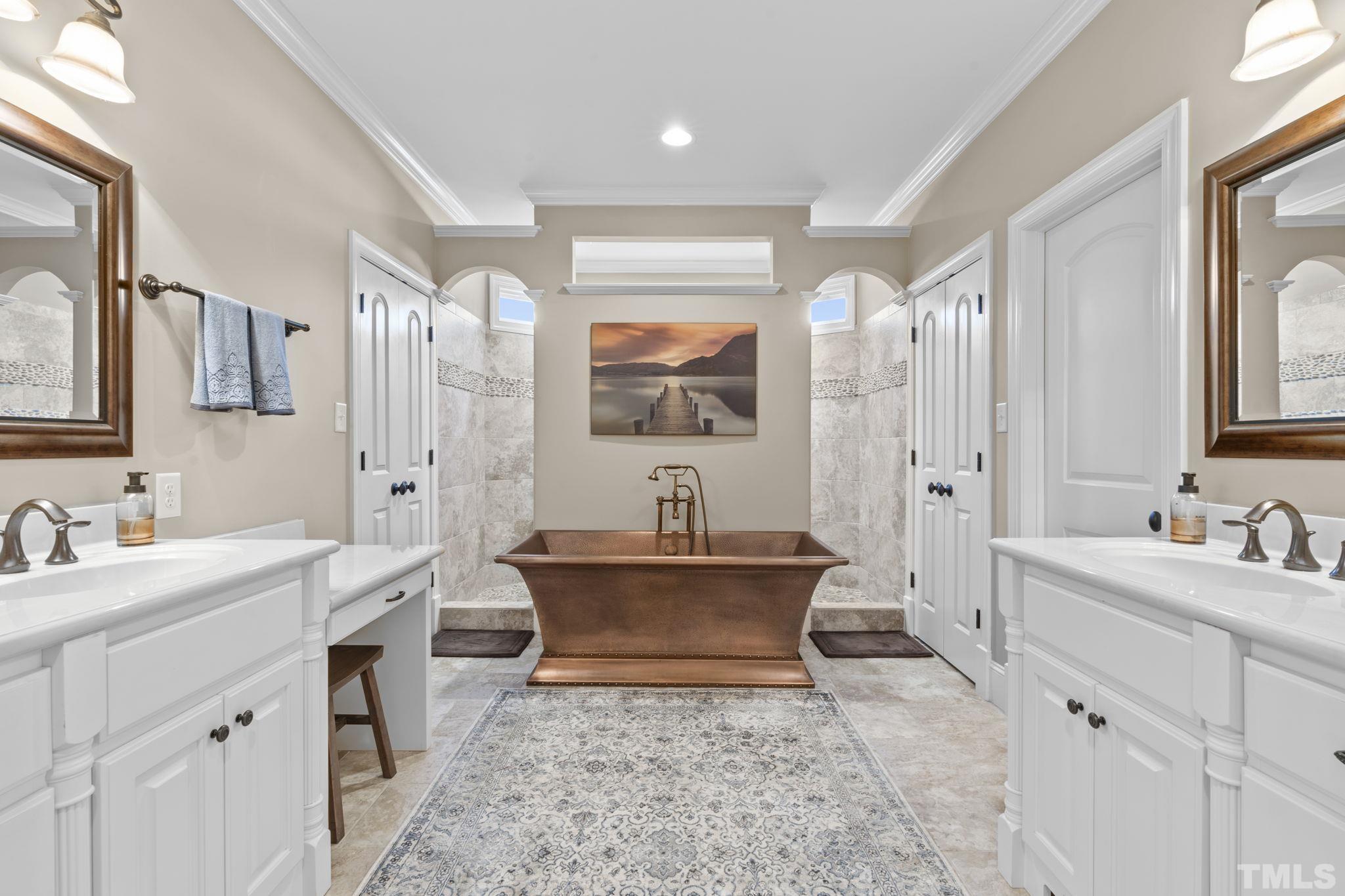 3976 Springfield Trail Wake Forest, NC 27587 - Photo 19 of 35 a spacious bathroom with a double vanity sink toilet mirror and bathtub