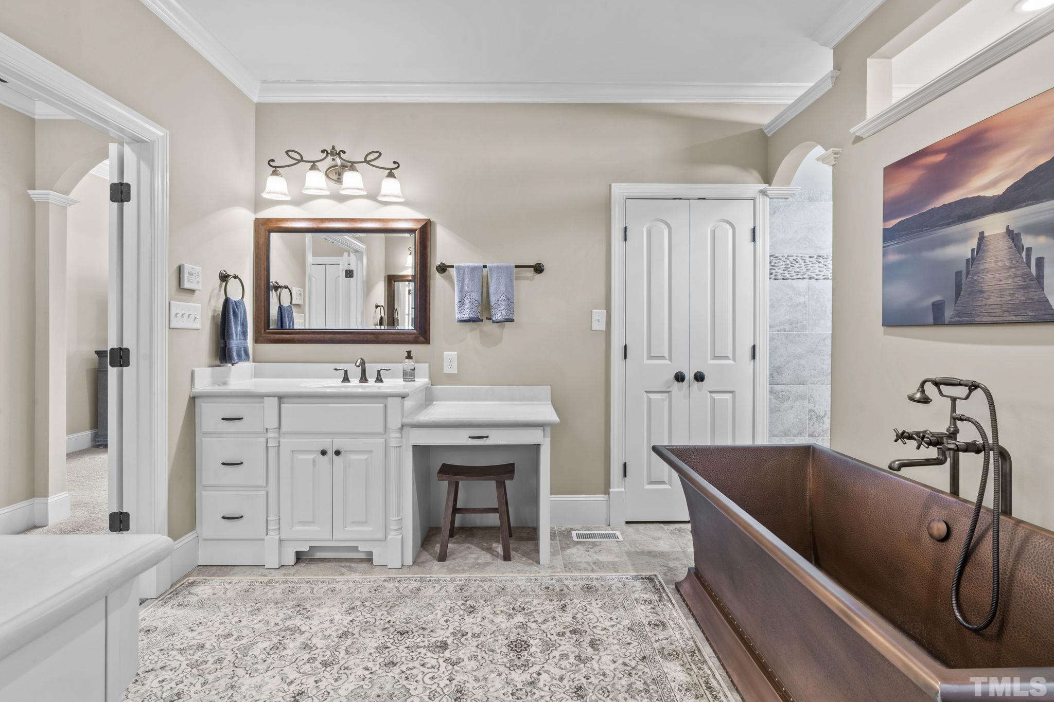 3976 Springfield Trail Wake Forest, NC 27587 - Photo 20 of 35 a spacious bathroom with a tub sink and mirror