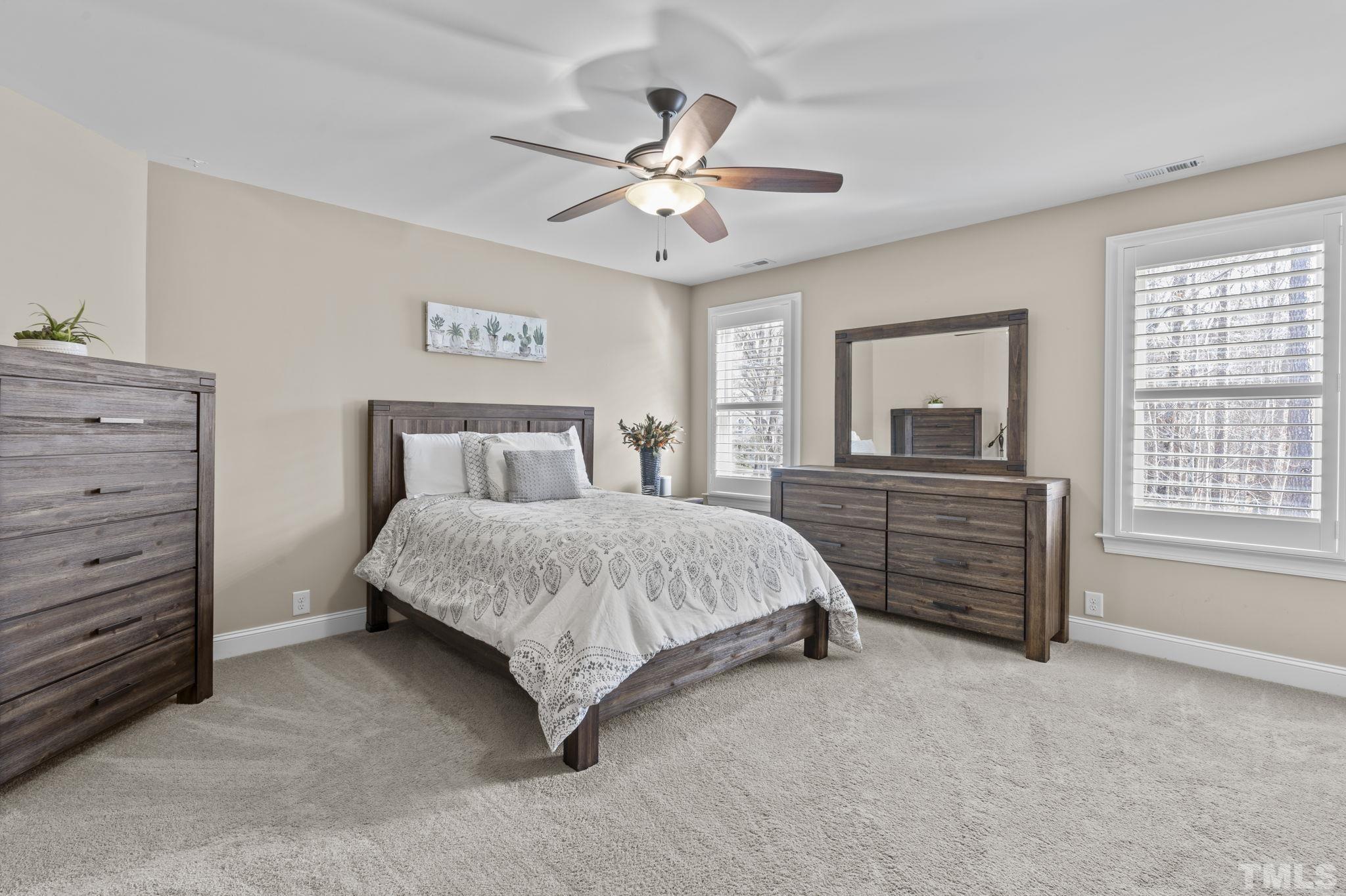 3976 Springfield Trail Wake Forest, NC 27587 - Photo 22 of 35 a bedroom with a bed and a chandelier