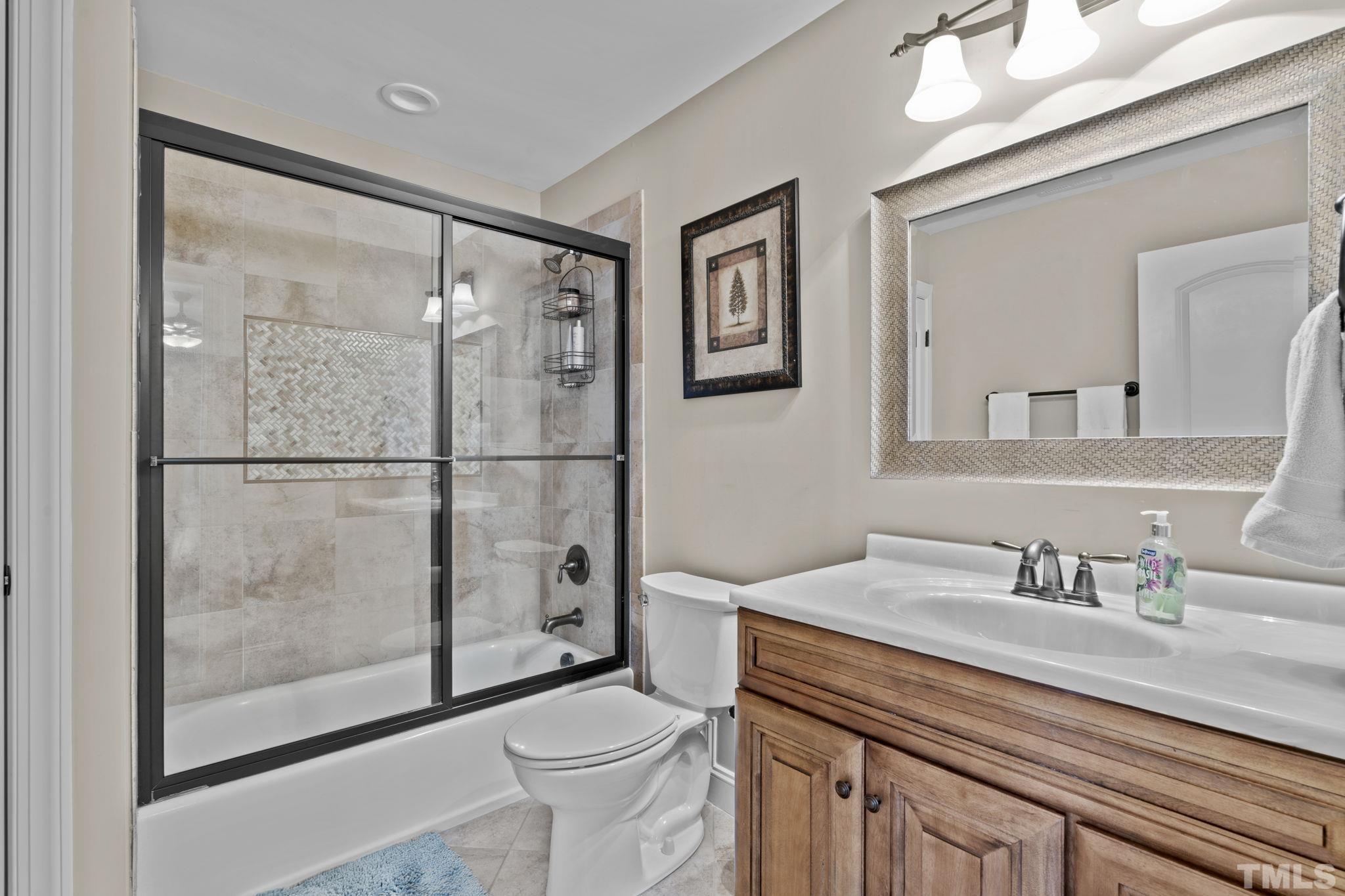 3976 Springfield Trail Wake Forest, NC 27587 - Photo 23 of 35 a bathroom with a sink a toilet and shower