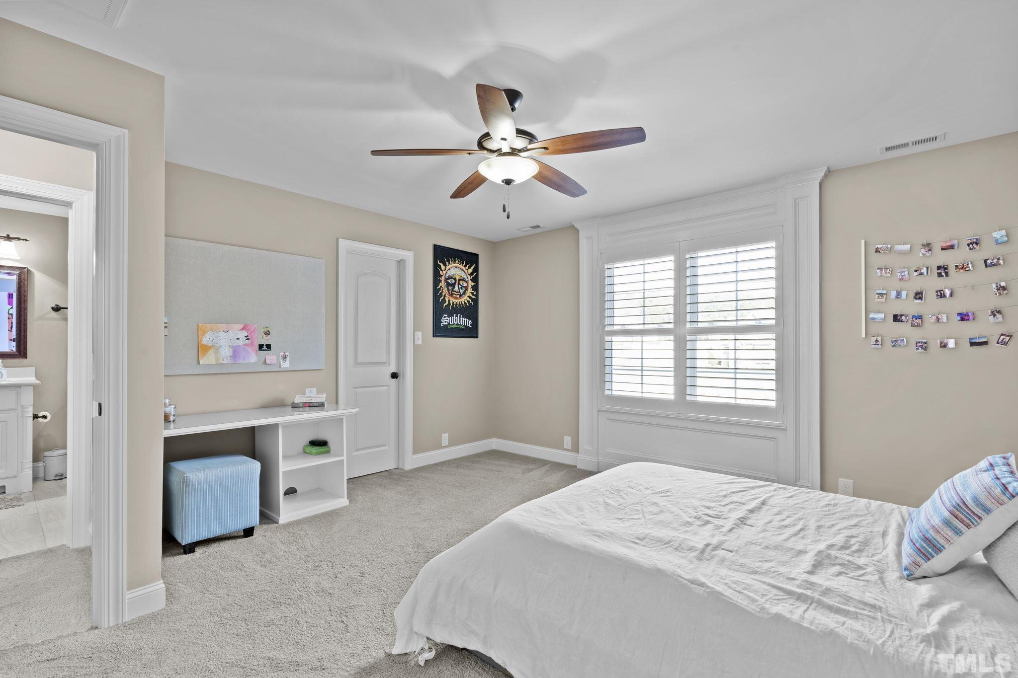 3976 Springfield Trail Wake Forest, NC 27587 - Photo 24 of 35 a bedroom with a bed and a chandelier