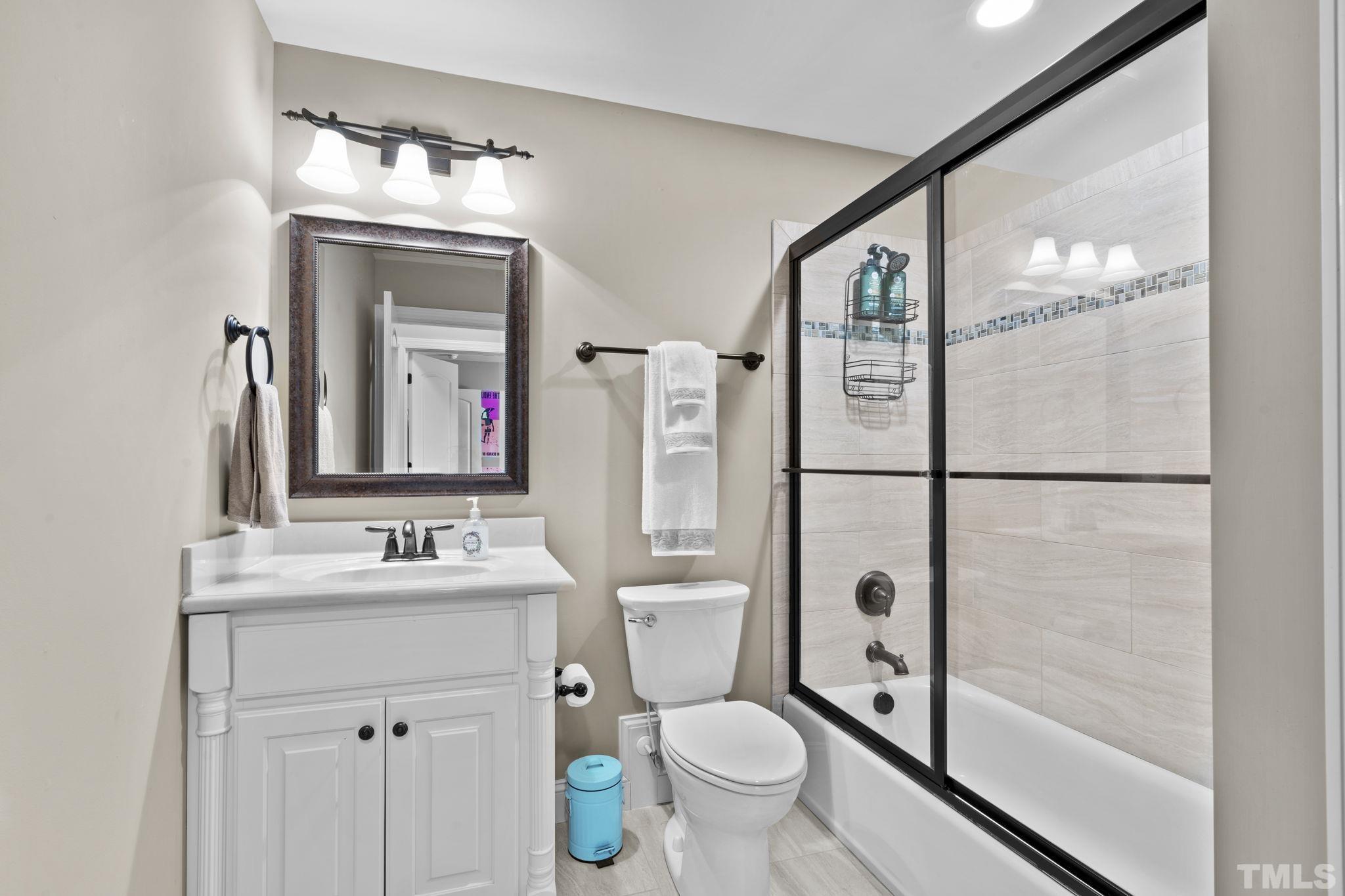 3976 Springfield Trail Wake Forest, NC 27587 - Photo 25 of 35 a bathroom with a toilet a sink and a mirror