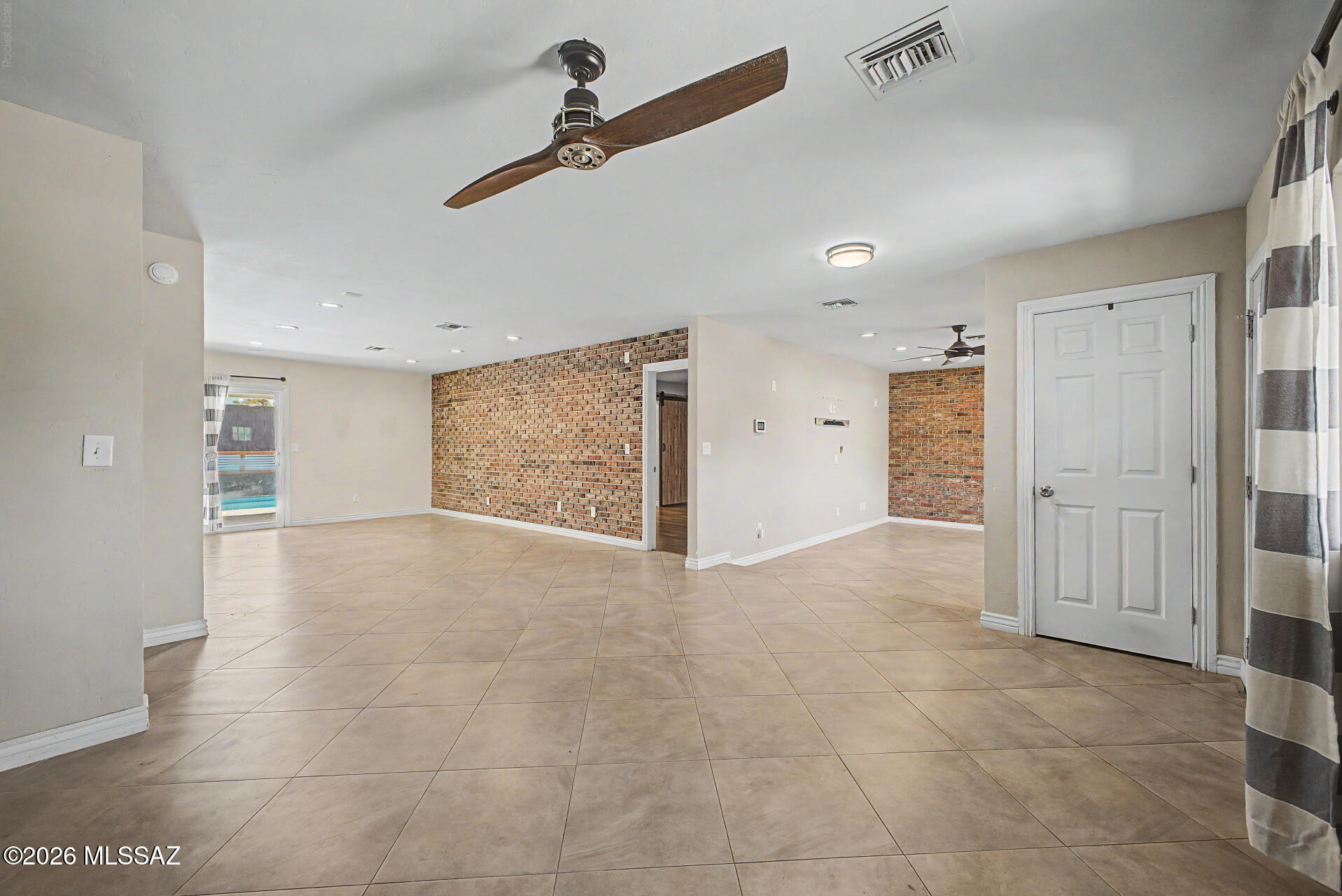 7550 East Rio Verde Drive Tucson, AZ 85715 - Photo 6 of 25 Beautiful brick accent walls add warmth and character to the heart of the home.