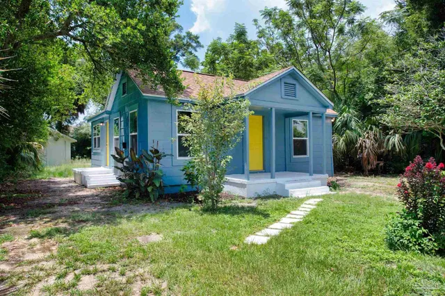 a front view of a house with a yard and pathway