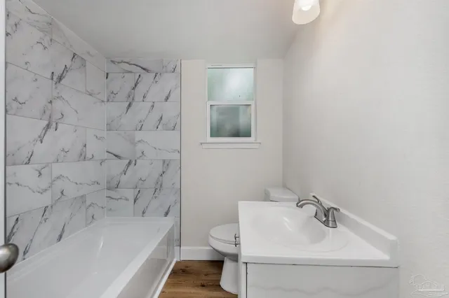 a bathroom with a sink toilet and bathtub