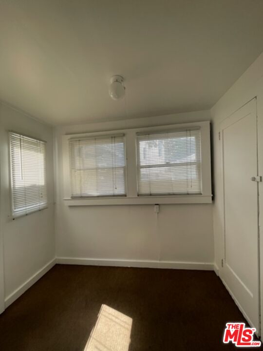 1304 Riviera Avenue, Unit D Venice, CA 90291 - Photo 15 of 17 an empty room with wooden floor and windows