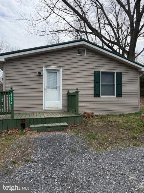 9012 Rabbit Road North Greencastle, PA 17225 - Photo 2 of 5 a small white house with a yard and garage