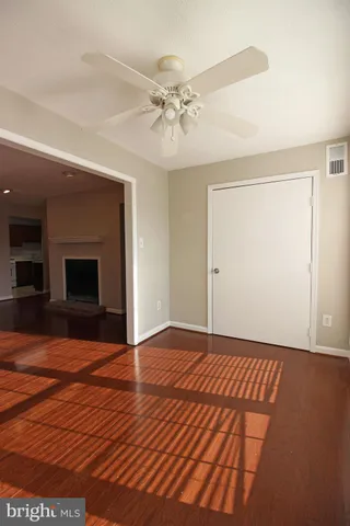 wooden floor in an empty room with a fireplace