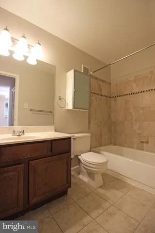 a bathroom with a sink a toilet and bathtub