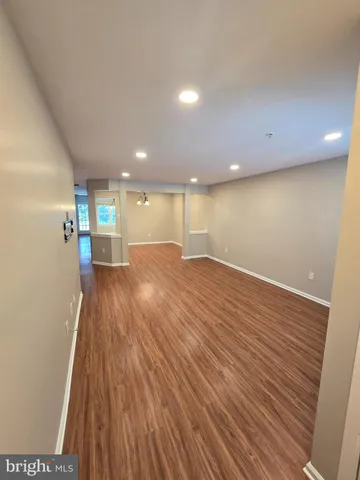 a view of a room with wooden floor