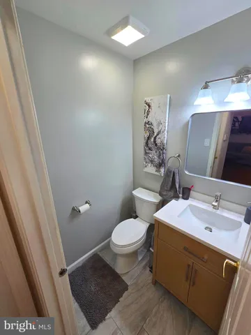 a bathroom with a sink a toilet a mirror and vanity