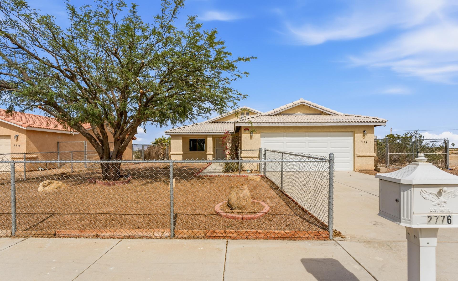 2776 Leto Avenue Thermal, CA 92274 - Photo 1 of 44 a view of a white house with a large tree