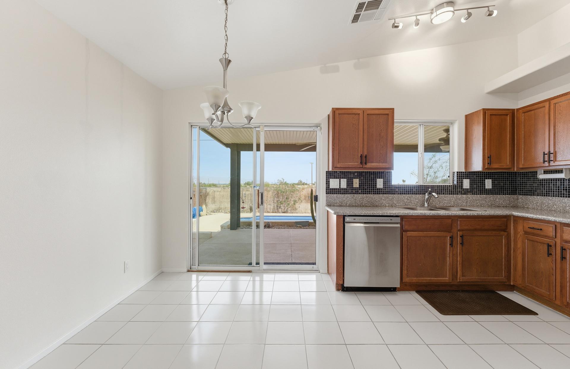 2776 Leto Avenue Thermal, CA 92274 - Photo 13 of 44 a kitchen with stainless steel appliances granite countertop a refrigerator and a stove top oven