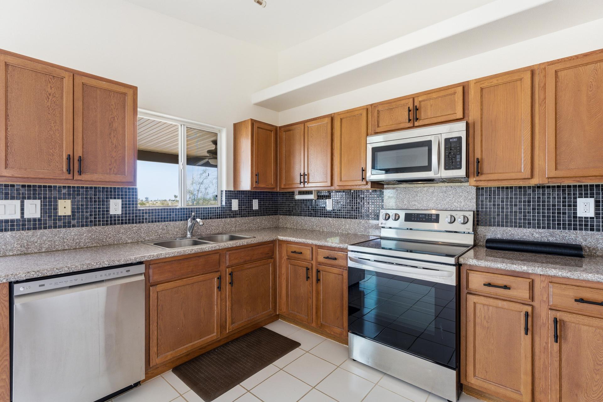2776 Leto Avenue Thermal, CA 92274 - Photo 15 of 44 a kitchen with cabinets appliances a sink and a counter top space