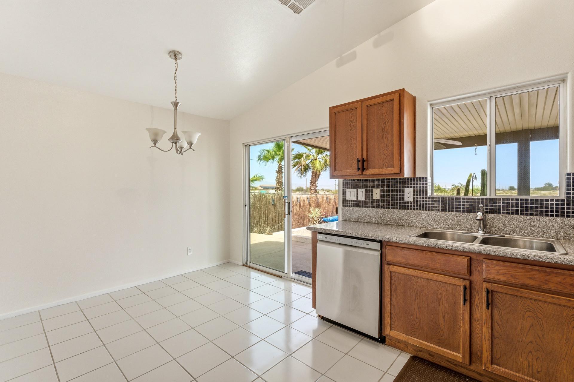 2776 Leto Avenue Thermal, CA 92274 - Photo 16 of 44 a kitchen with stainless steel appliances granite countertop a sink and a window