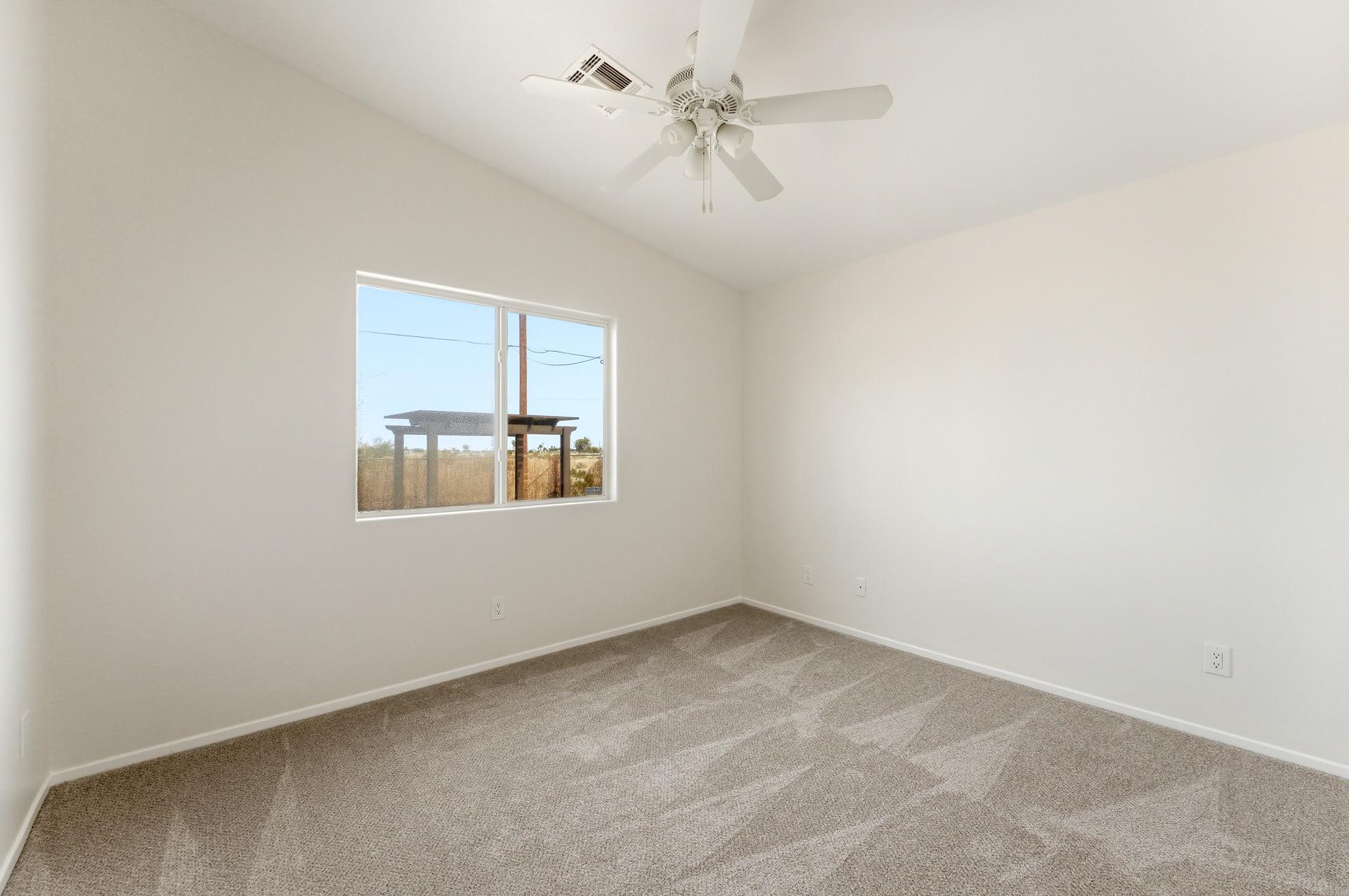 2776 Leto Avenue Thermal, CA 92274 - Photo 18 of 44 an empty room with windows and fan