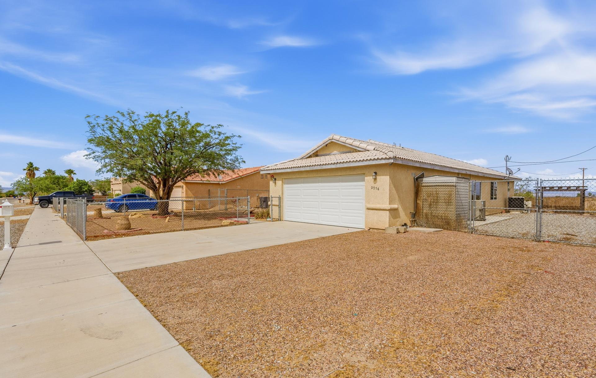 2776 Leto Avenue Thermal, CA 92274 - Photo 6 of 44 a front view of a house with a yard and garage