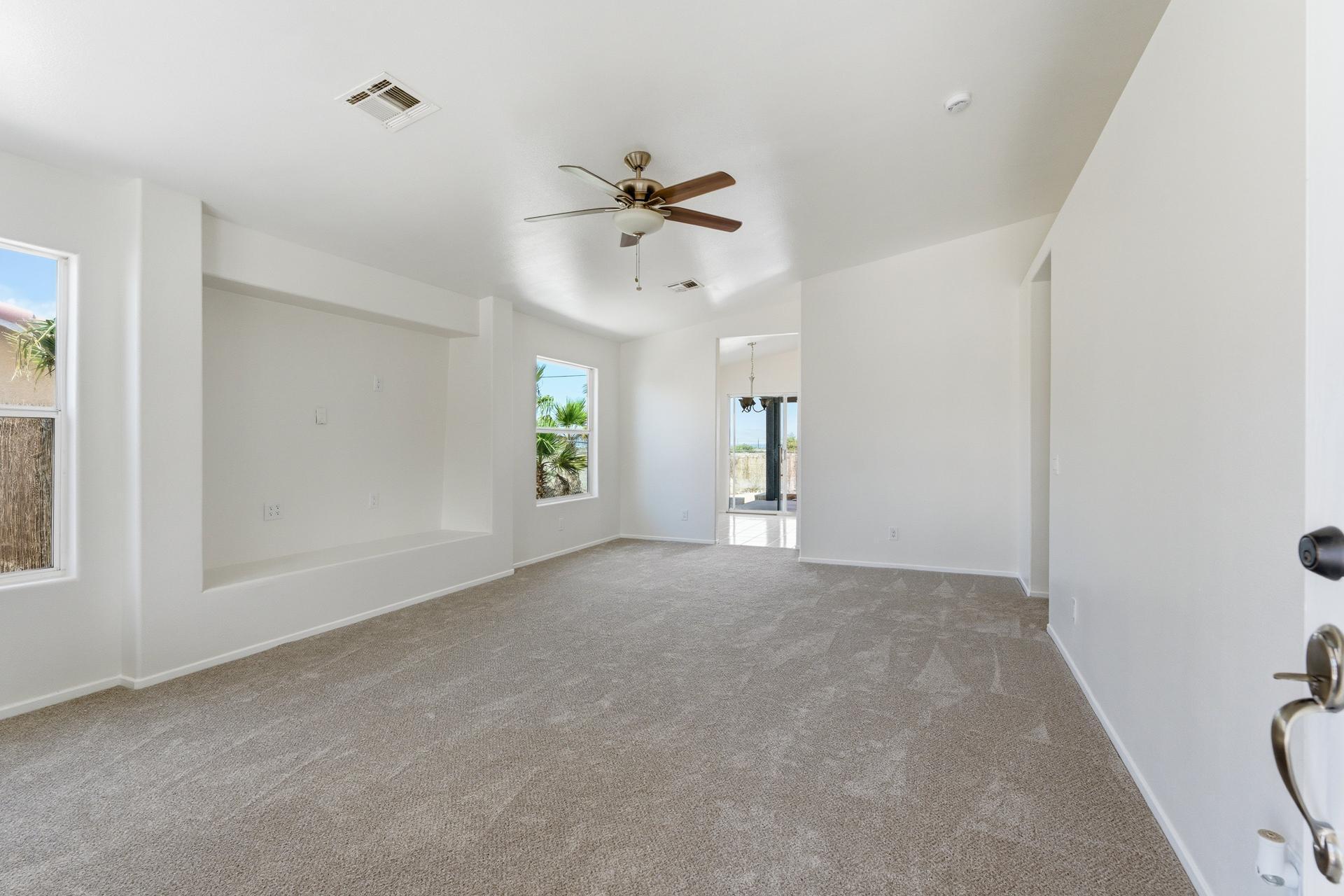 2776 Leto Avenue Thermal, CA 92274 - Photo 9 of 44 a view of a big room with windows and chandelier fan