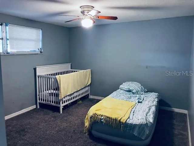 a bedroom with 2 bed and a window