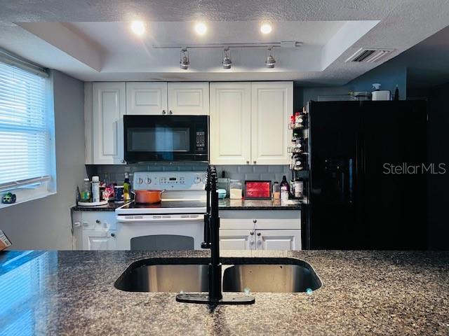 3841 Chaffey Drive New Port Richey, FL 34652 - Photo 5 of 18 a kitchen with stainless steel appliances granite countertop a sink and a refrigerator