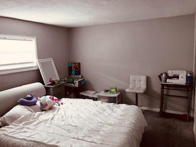 3841 Chaffey Drive New Port Richey, FL 34652 - Photo 10 of 18 a bedroom with a bed and chair