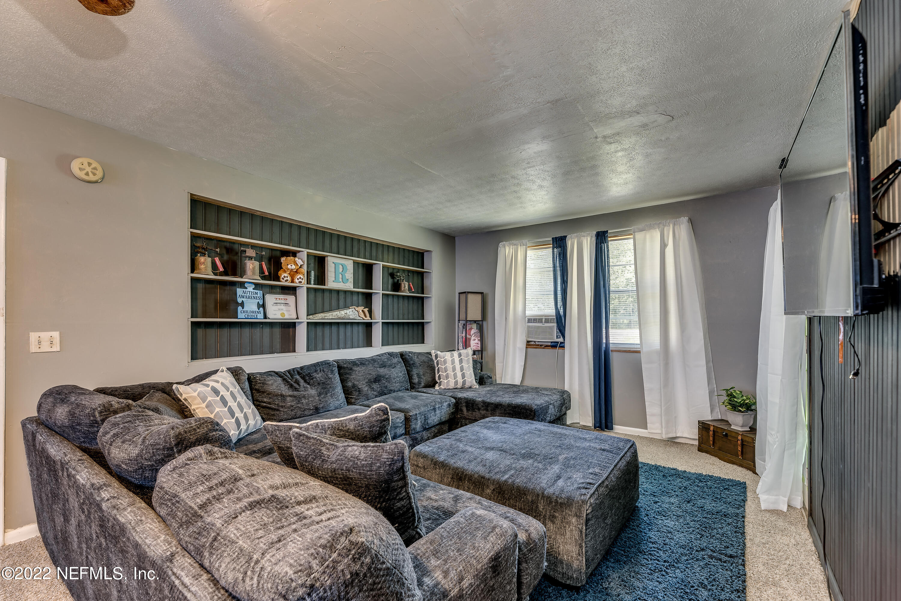 2149 Chaffee Road South Jacksonville, FL 32221 - Photo 7 of 19 a living room with furniture and a book shelf