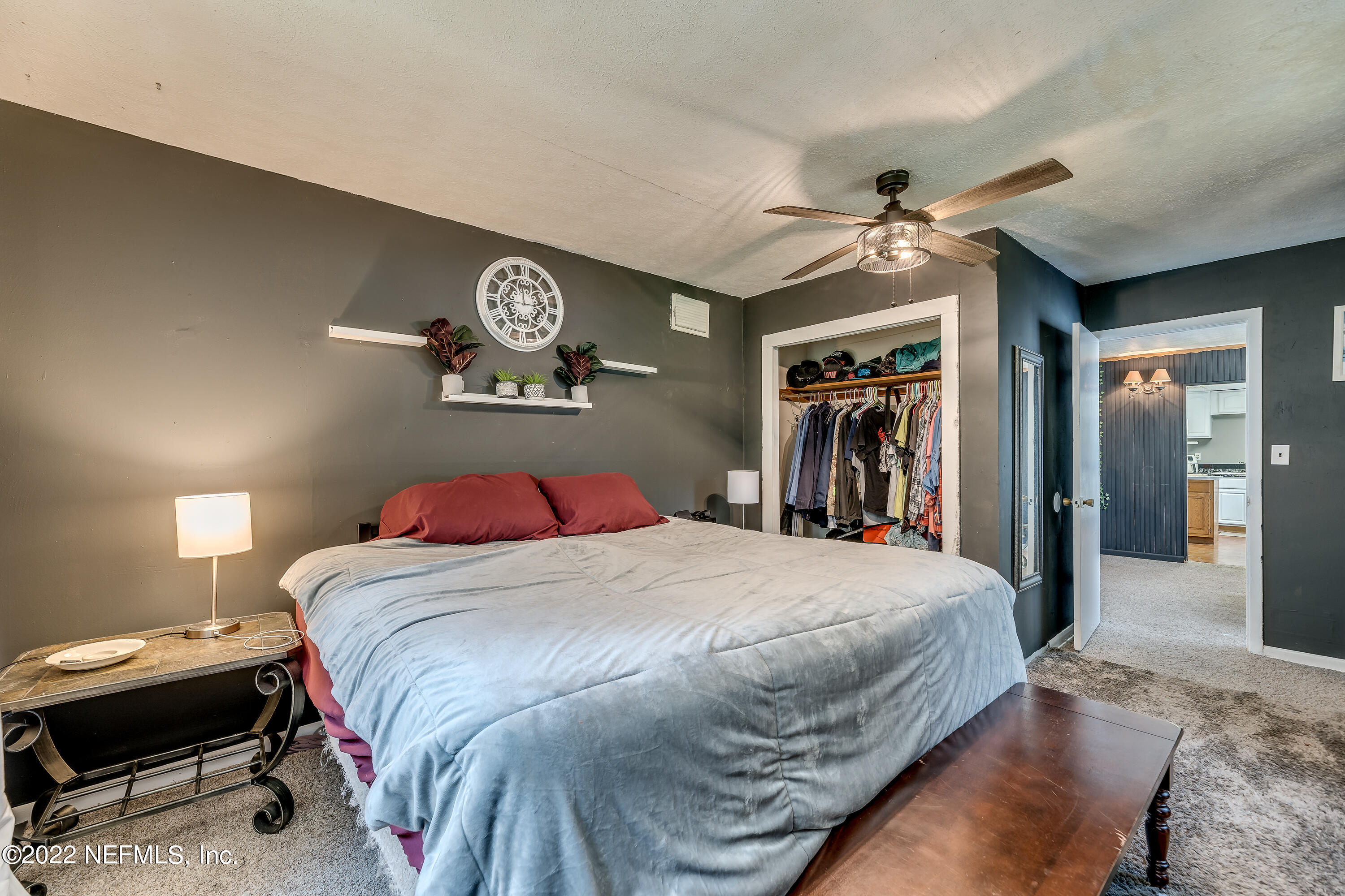 2149 Chaffee Road South Jacksonville, FL 32221 - Photo 10 of 19 a bedroom with a bed and a chandelier