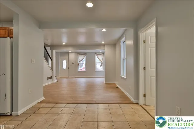 a kitchen with stainless steel appliances granite countertop a refrigerator sink and stove