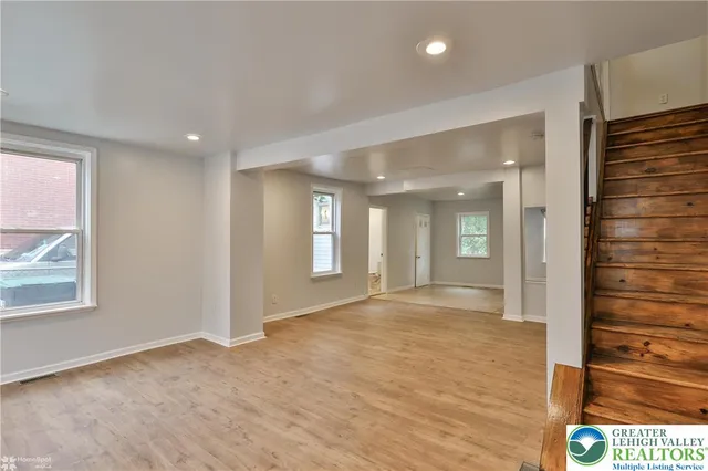 a view of an empty room with stairs and stairs