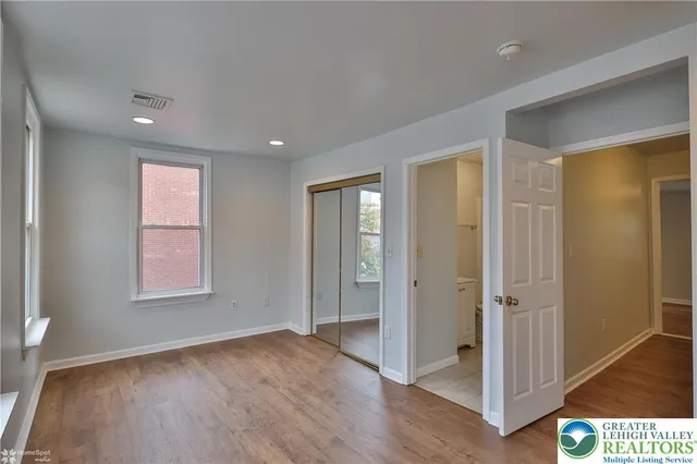 a balcony with wooden floor and trees in the back